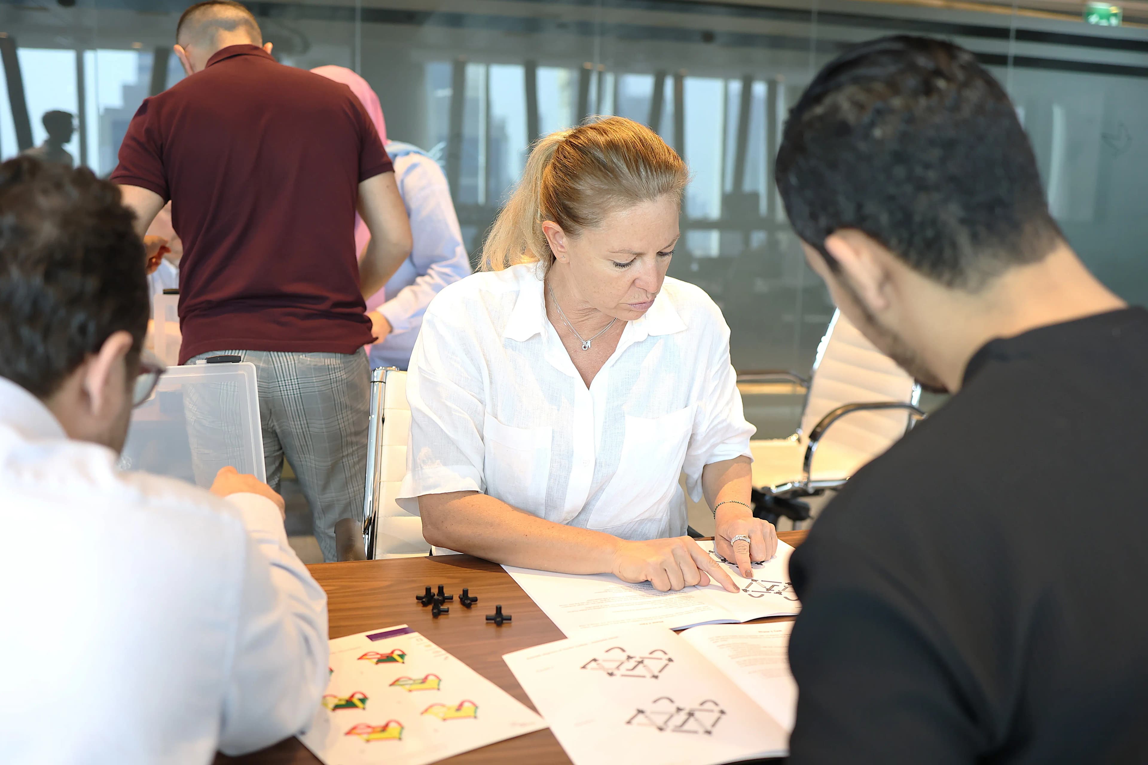 Group engaging in MTa KanDo Lean activity, focusing on maximising customer value and precision.