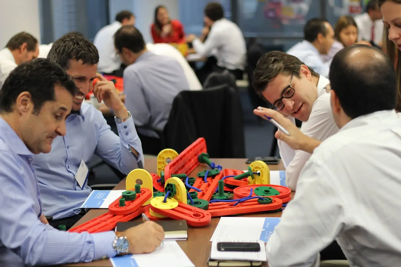A group using the MTa Insights Kit, engaging in a high-impact activity for quick team development.